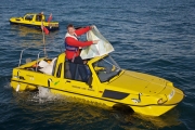 Doug Hilton pointing at a map in the middle of the English Channel in his Dutton amphibious car